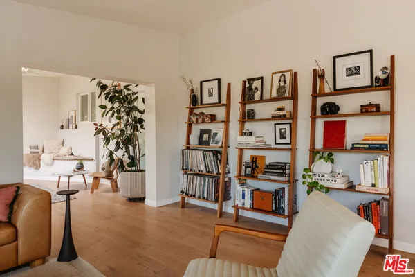 a living room with furniture cabinets and book shelf