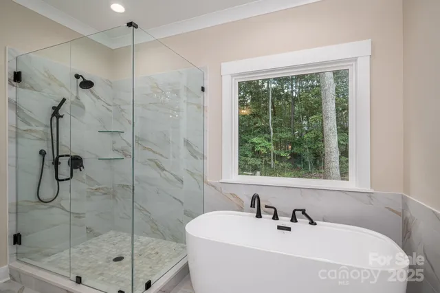a bathroom with a shower sink and mirror