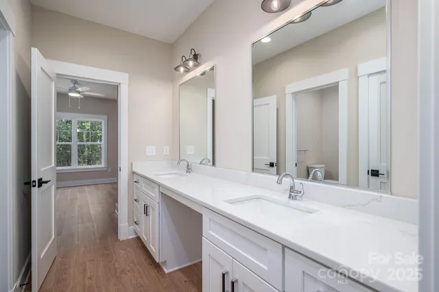 a bathroom with a sink double vanity granite tub and shower