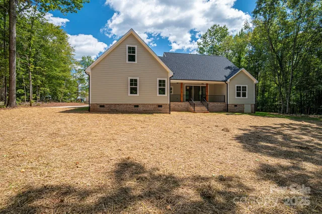 a front view of house with yard and trees