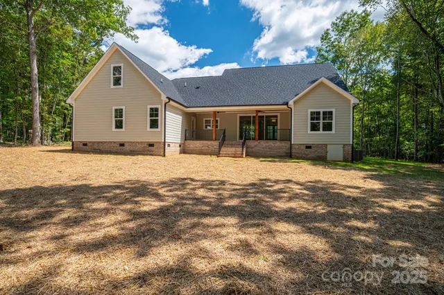 a front view of a house with a yard covered in snow