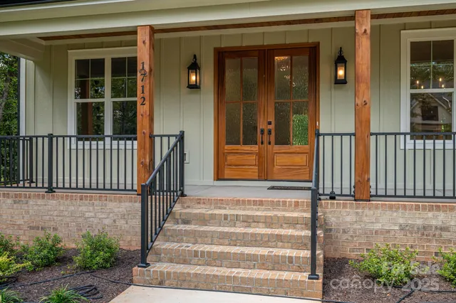 a view of front door of house with stairs