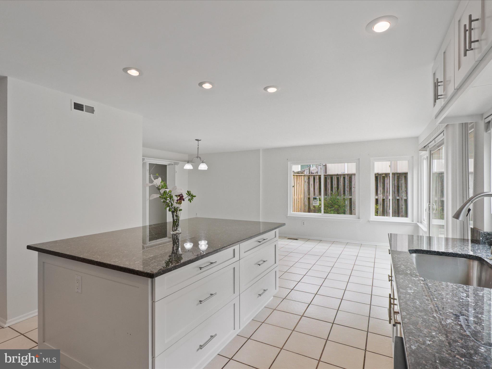5922 Hall Street Springfield, VA 22152 - Photo 18 of 47 a hall with kitchen island granite countertop a sink and a granite counter tops