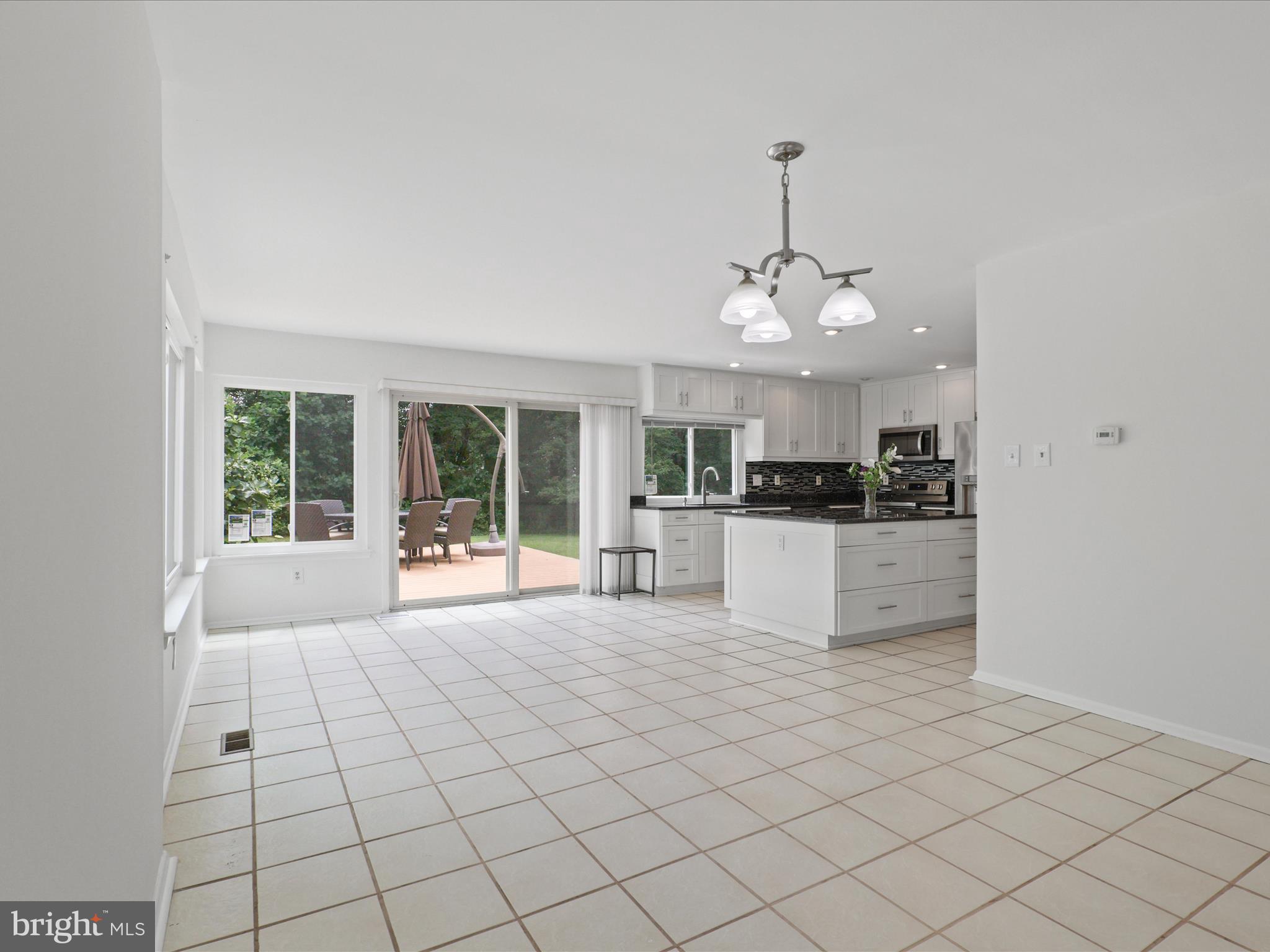 5922 Hall Street Springfield, VA 22152 - Photo 20 of 47 a large white kitchen with a cabinetry and chandelier