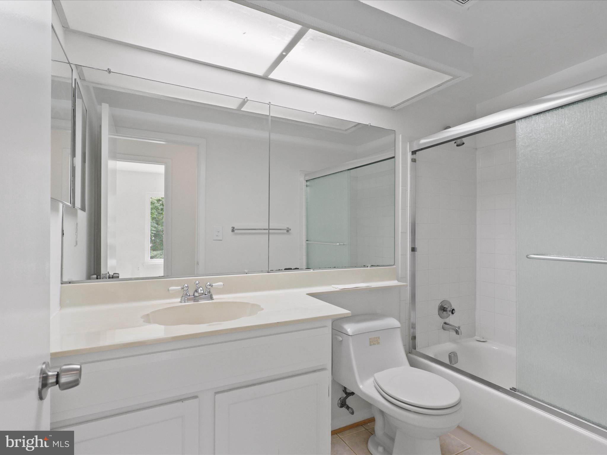 5922 Hall Street Springfield, VA 22152 - Photo 31 of 47 a bathroom with a sink toilet vanity and shower