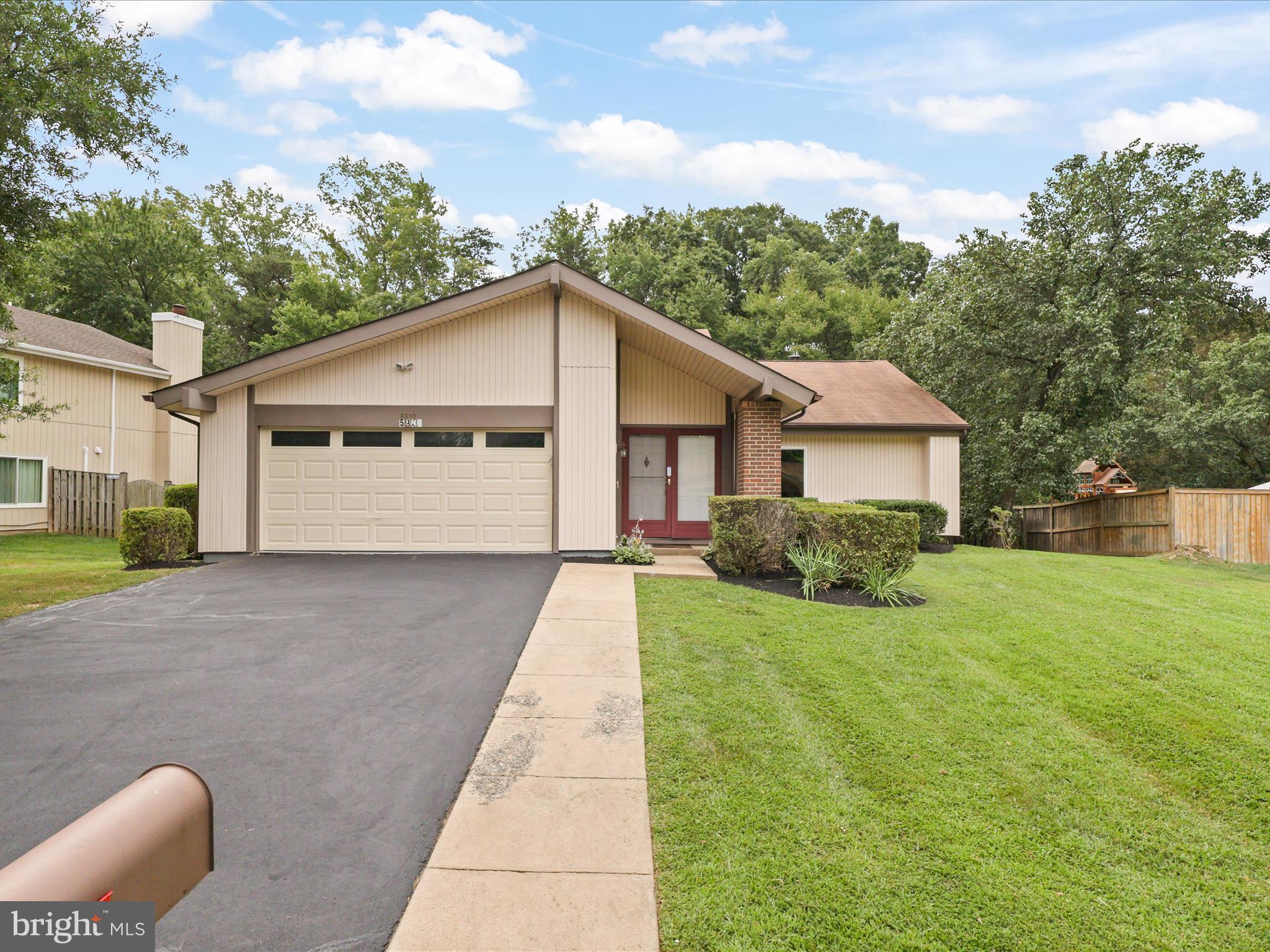 5922 Hall Street Springfield, VA 22152 - Photo 4 of 47 a front view of a house with garden