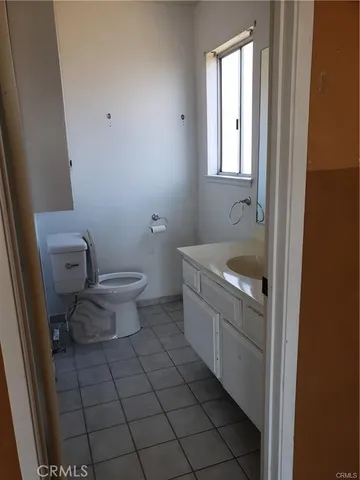 a bathroom with a sink toilet and window