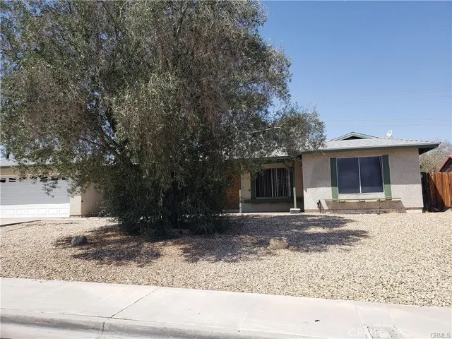a front view of a house with a yard and a garage