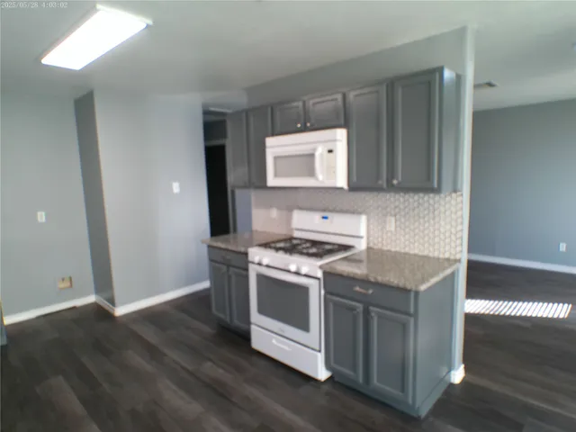 a kitchen with a stove and a microwave