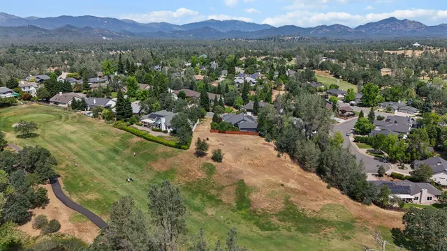 a view of a lush green hillside and houses