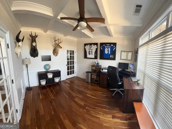 a view of a livingroom and dining room and hardwood floor