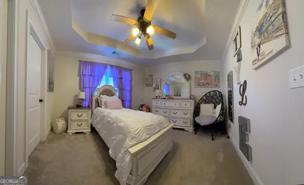 a bed room with a bed and a chandelier