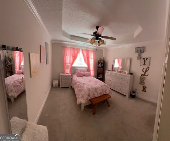 a bedroom with a bed dresser and a window