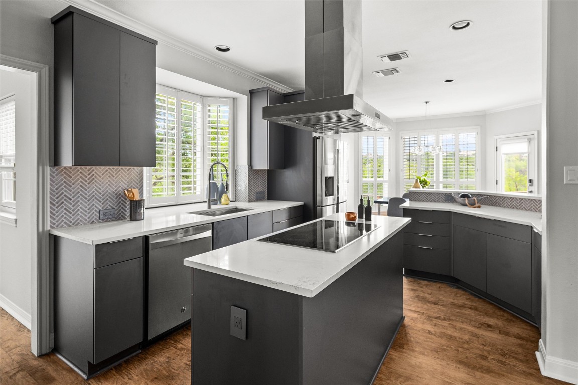 2807 Round Table Road Austin, TX 78746 - Photo 5 of 38 The open-concept kitchen is a chef’s dream, featuring:
• 36” ZLINE range hood
• Caesarstone countertops
• Kraus 32” stainless steel sink
• Large center island and breakfast bar
• Custom cabinetry and premium appliances