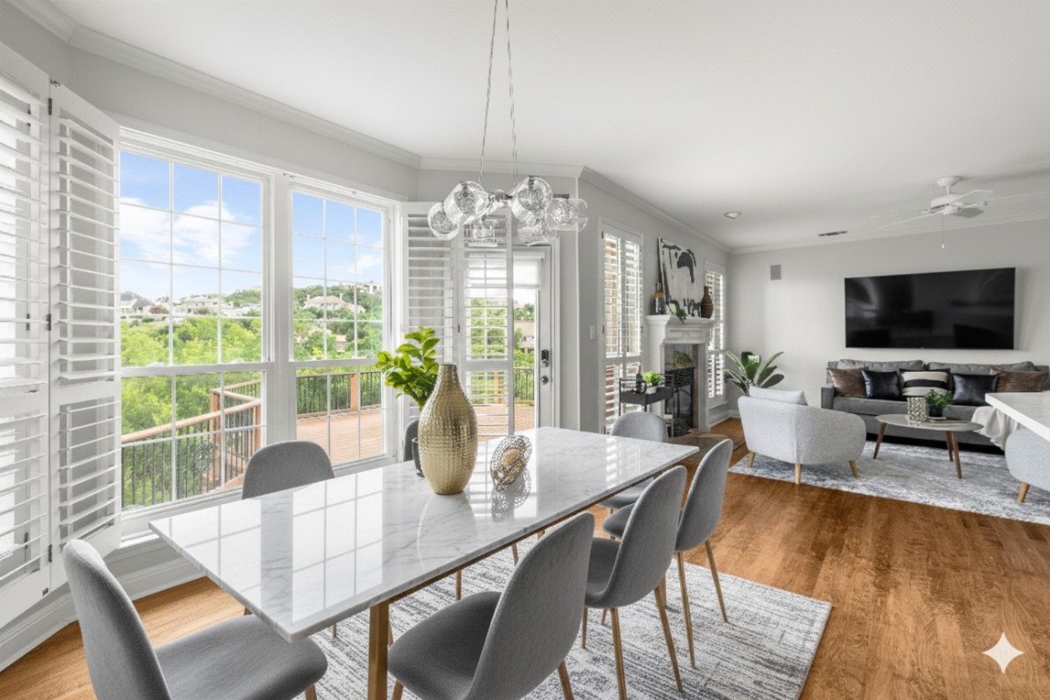 2807 Round Table Road Austin, TX 78746 - Photo 8 of 38 Dining area featuring crown molding, a fireplace, wood finished floors, ceiling fan, and a chandelier