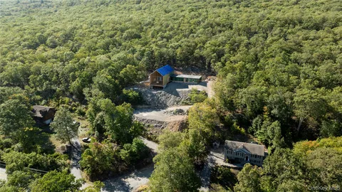 an aerial view of a house with a yard