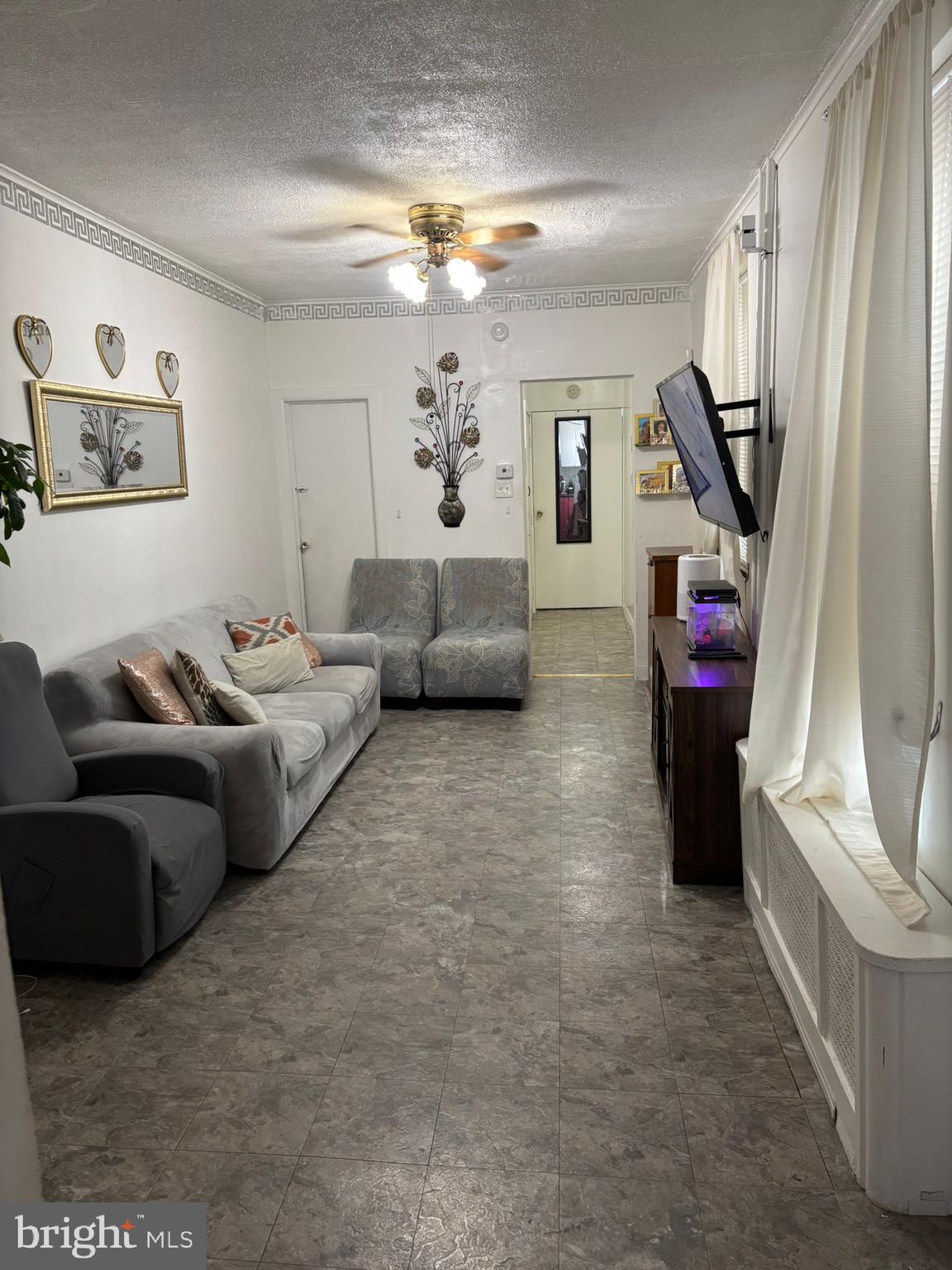 439 Buttonwood Street Reading, PA 19601 - Photo 11 of 33 a living room with furniture and a flat screen tv