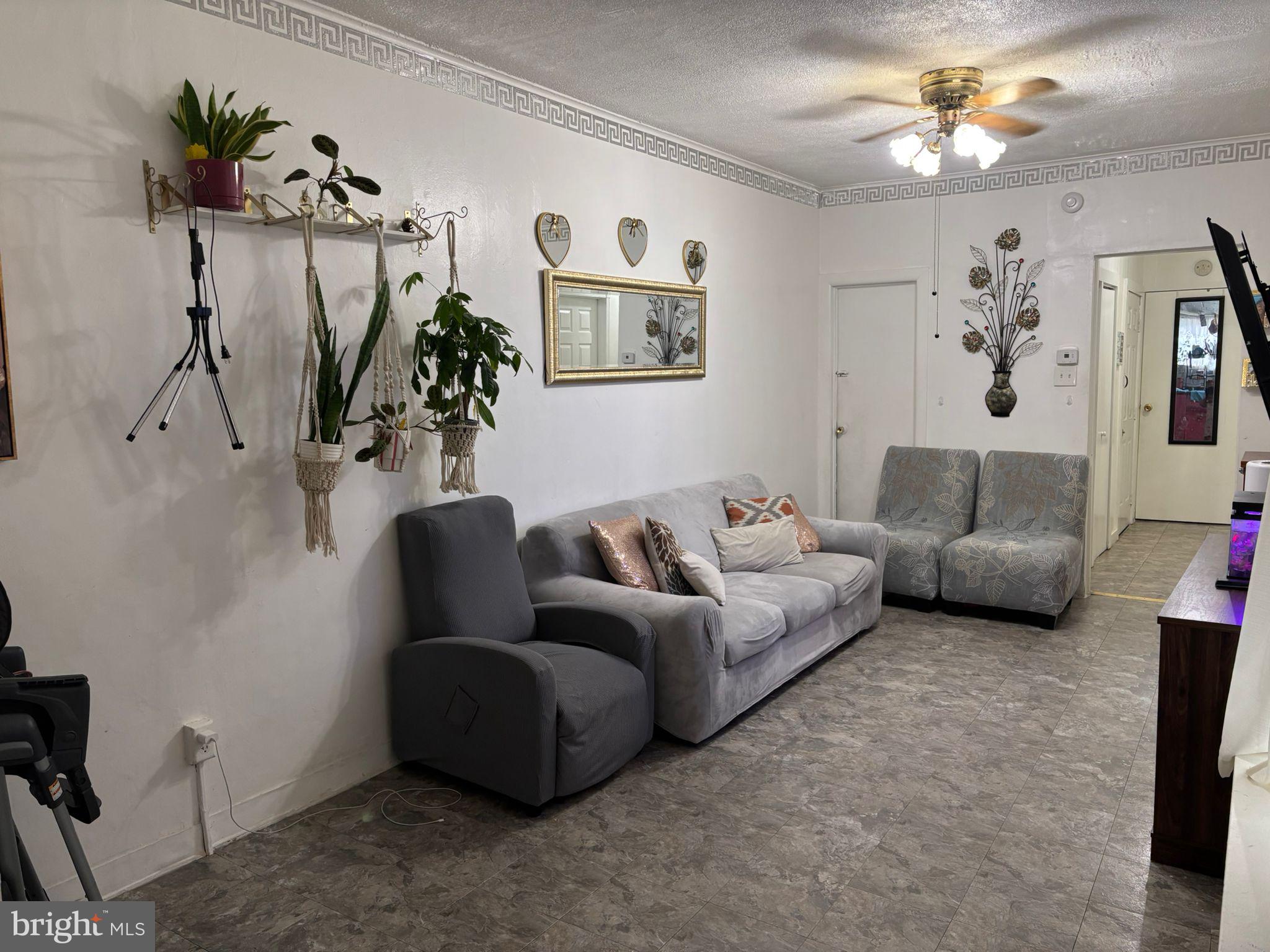 439 Buttonwood Street Reading, PA 19601 - Photo 12 of 33 a living room with furniture a chandelier and a window