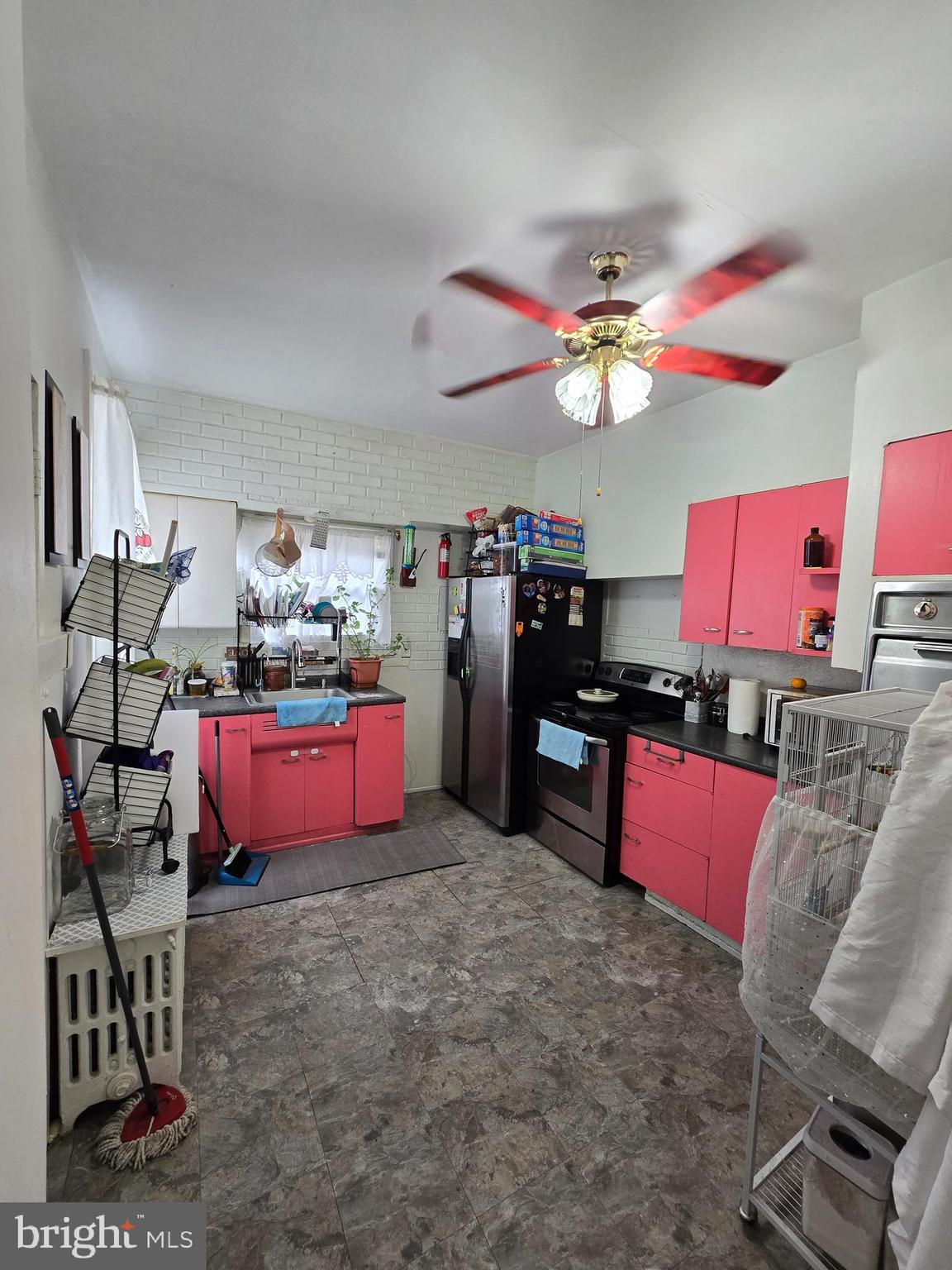 439 Buttonwood Street Reading, PA 19601 - Photo 14 of 33 a kitchen with granite countertop a stove and chairs