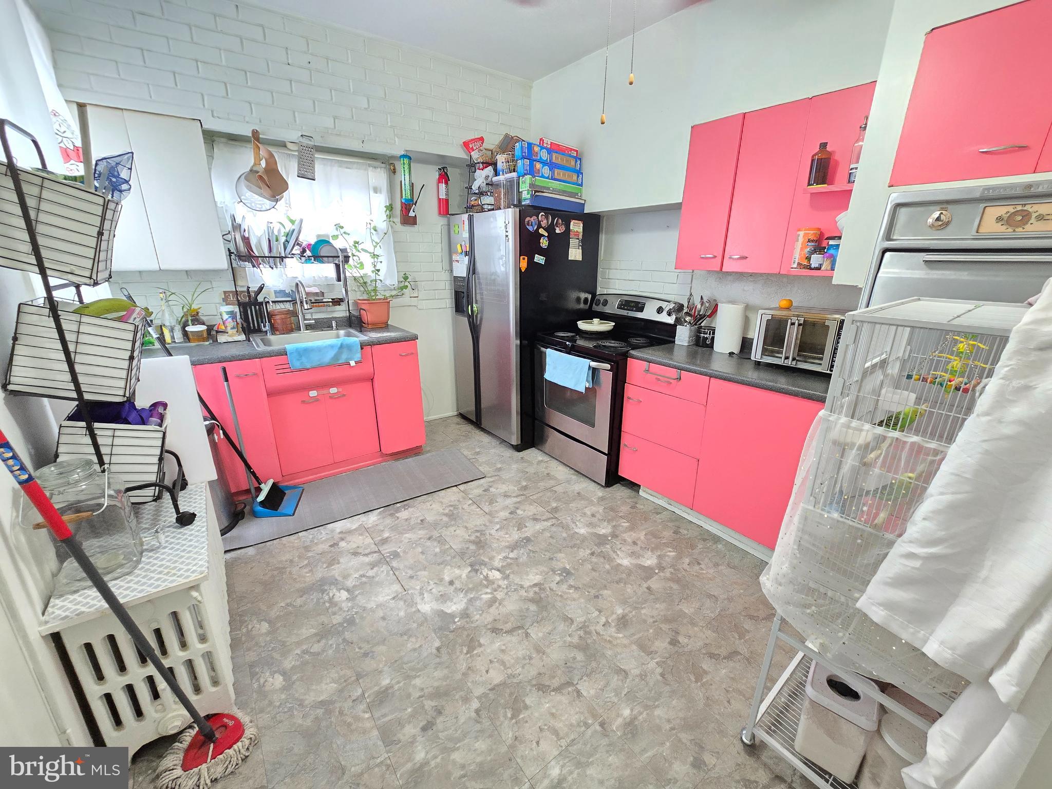 439 Buttonwood Street Reading, PA 19601 - Photo 15 of 33 a kitchen with stainless steel appliances kitchen island granite countertop a refrigerator stove and sink