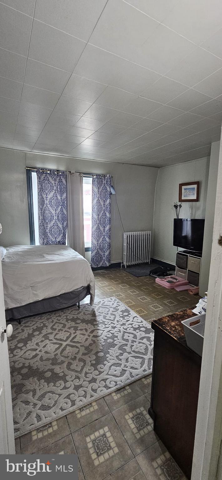 439 Buttonwood Street Reading, PA 19601 - Photo 19 of 33 a living room with hard wood floor and a fireplace