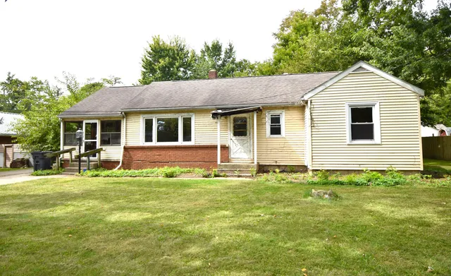 a front view of a house with a garden