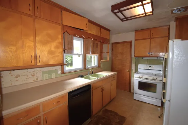a kitchen with a sink and a refrigerator
