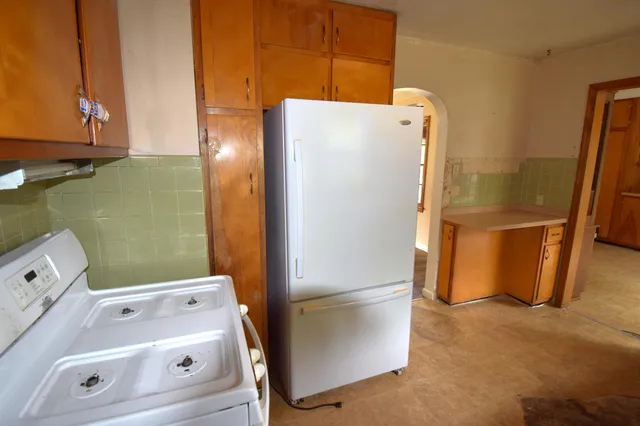 a white refrigerator freezer sitting in a kitchen