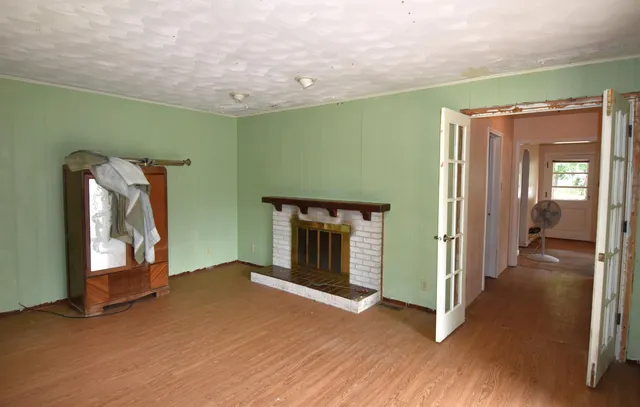 a view of empty room with window and fireplace