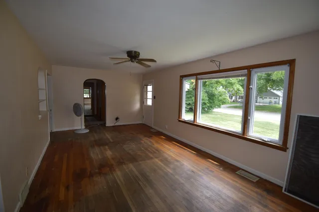 a view of a livingroom with a fireplace and window