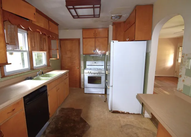a kitchen with refrigerator cabinets and a sink