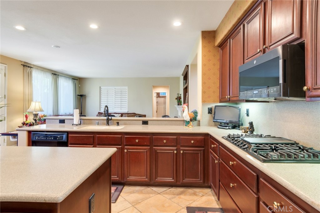 2967 Mangular Avenue Corona, CA 92882 - Photo 18 of 37 a kitchen with a sink a stove and cabinets