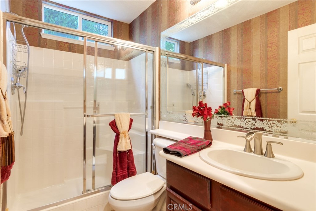 2967 Mangular Avenue Corona, CA 92882 - Photo 21 of 37 a bathroom with a sink vanity mirror and toilet