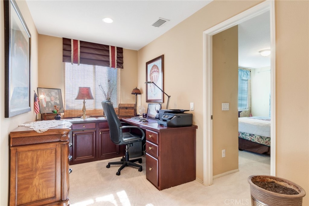 2967 Mangular Avenue Corona, CA 92882 - Photo 24 of 37 a view of a workspace with furniture and a window