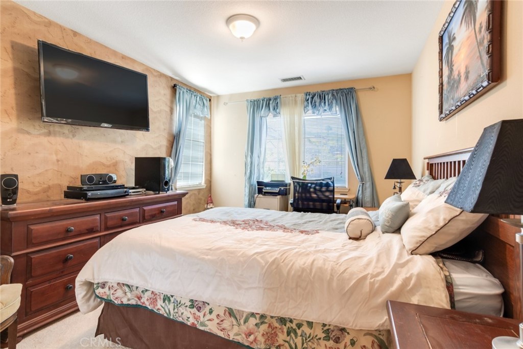 2967 Mangular Avenue Corona, CA 92882 - Photo 26 of 37 a bedroom with a bed and a flat screen tv