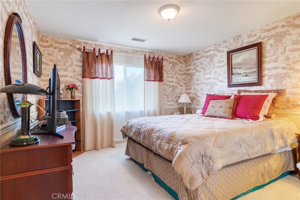 2967 Mangular Avenue Corona, CA 92882 - Photo 27 of 37 a bedroom with a bed table and a mirror