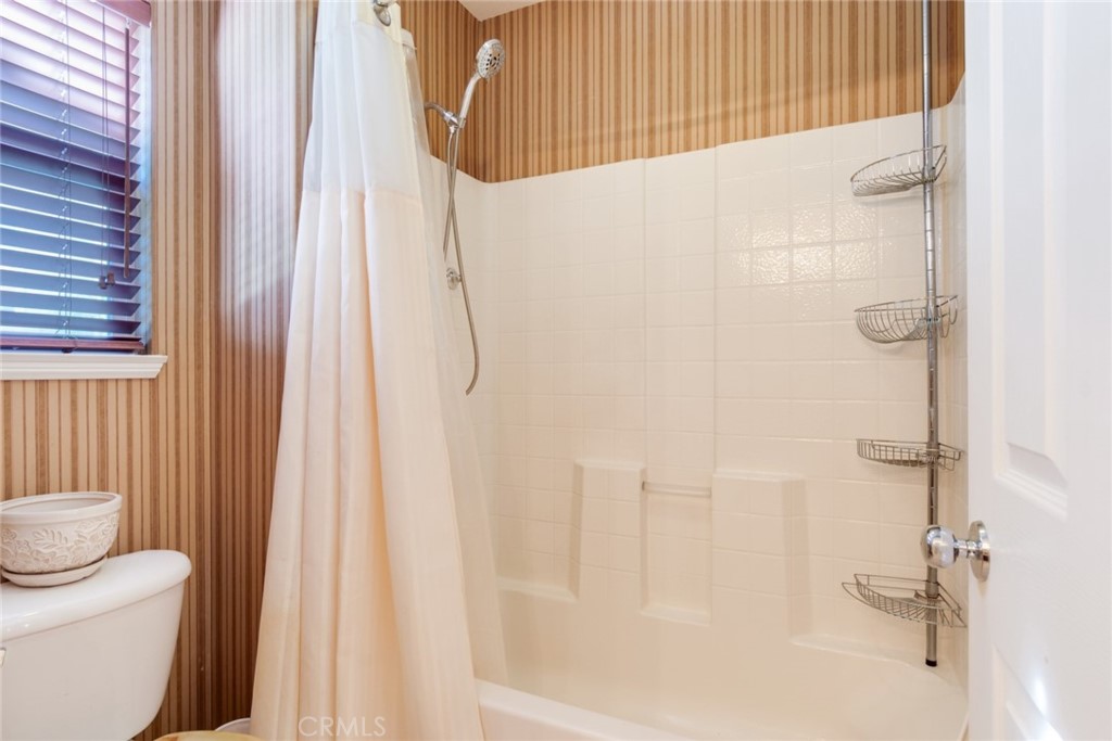 2967 Mangular Avenue Corona, CA 92882 - Photo 29 of 37 a bathroom with a shower curtain