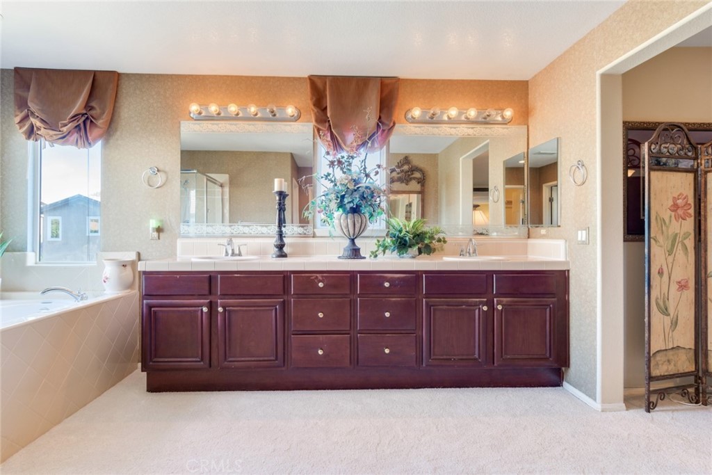 2967 Mangular Avenue Corona, CA 92882 - Photo 30 of 37 a bathroom with a double vanity sink and a mirror