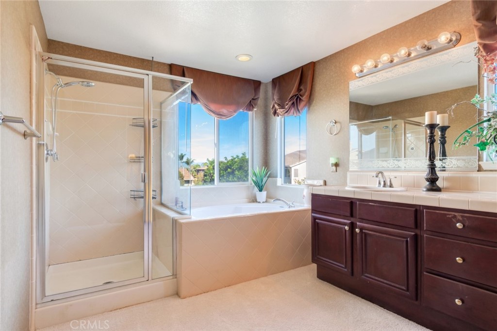 2967 Mangular Avenue Corona, CA 92882 - Photo 31 of 37 a spacious bathroom with a double vanity sink mirror and shower