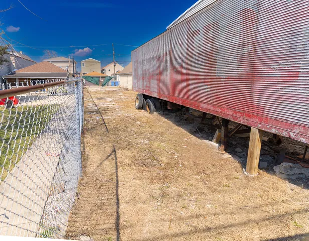 a view of a backyard with wooden fence
