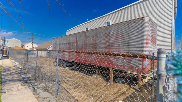 a view of a back yard with a wooden fence