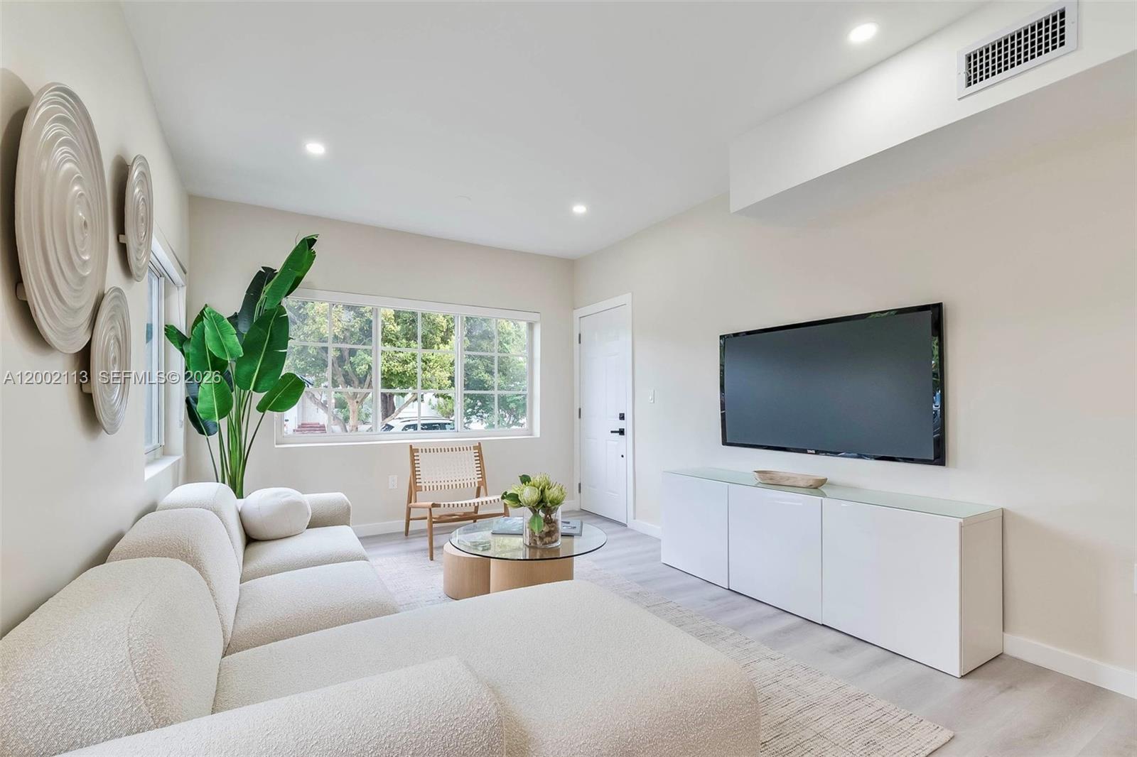 1852 Southwest 22nd Terrace, Unit 2 Miami, FL 33145 - Photo 4 of 20 a living room with furniture and a flat screen tv