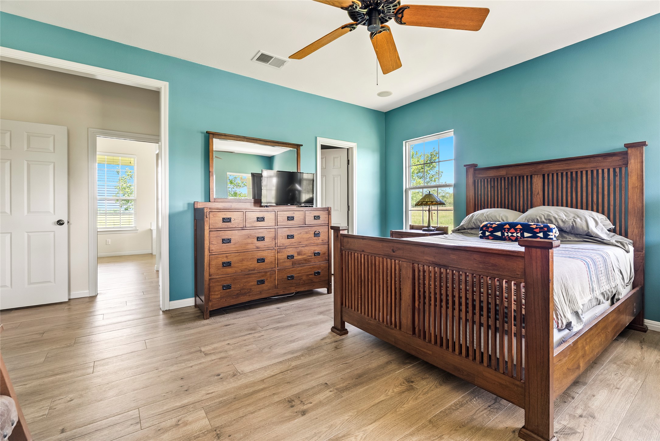 928 Upper Elgin River Road Elgin, TX 78621 - Photo 20 of 40 Spacious room featuring wood-finish flooring, a ceiling fan, and a window.