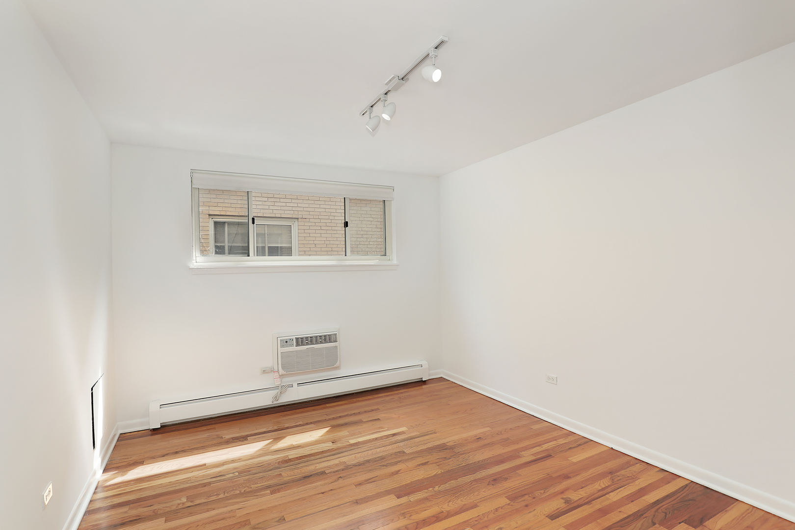 2730 Central Street, Unit 3A Evanston, IL 60201 - Photo 11 of 18 a view of empty room with wooden floor and fan