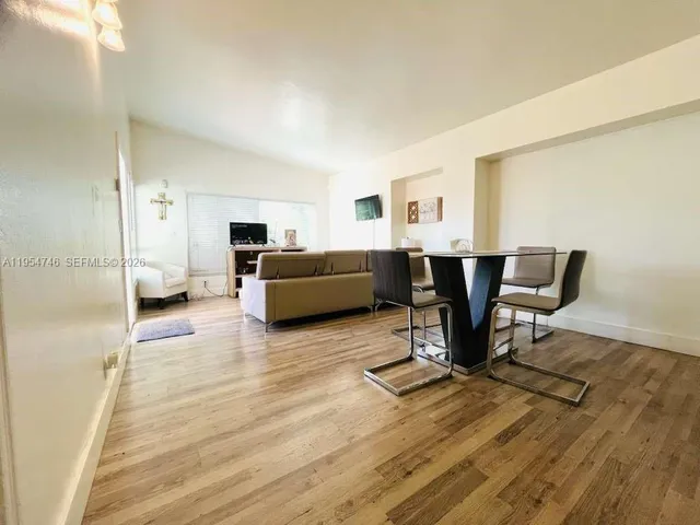 a view of a livingroom with furniture and a workspace