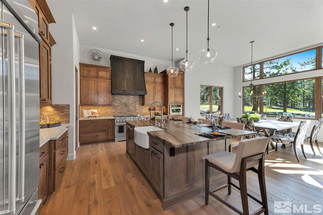 249 Mill Race Loop Carson City, NV 89705 - Photo 12 of 40 a kitchen with a table chairs stove and refrigerator