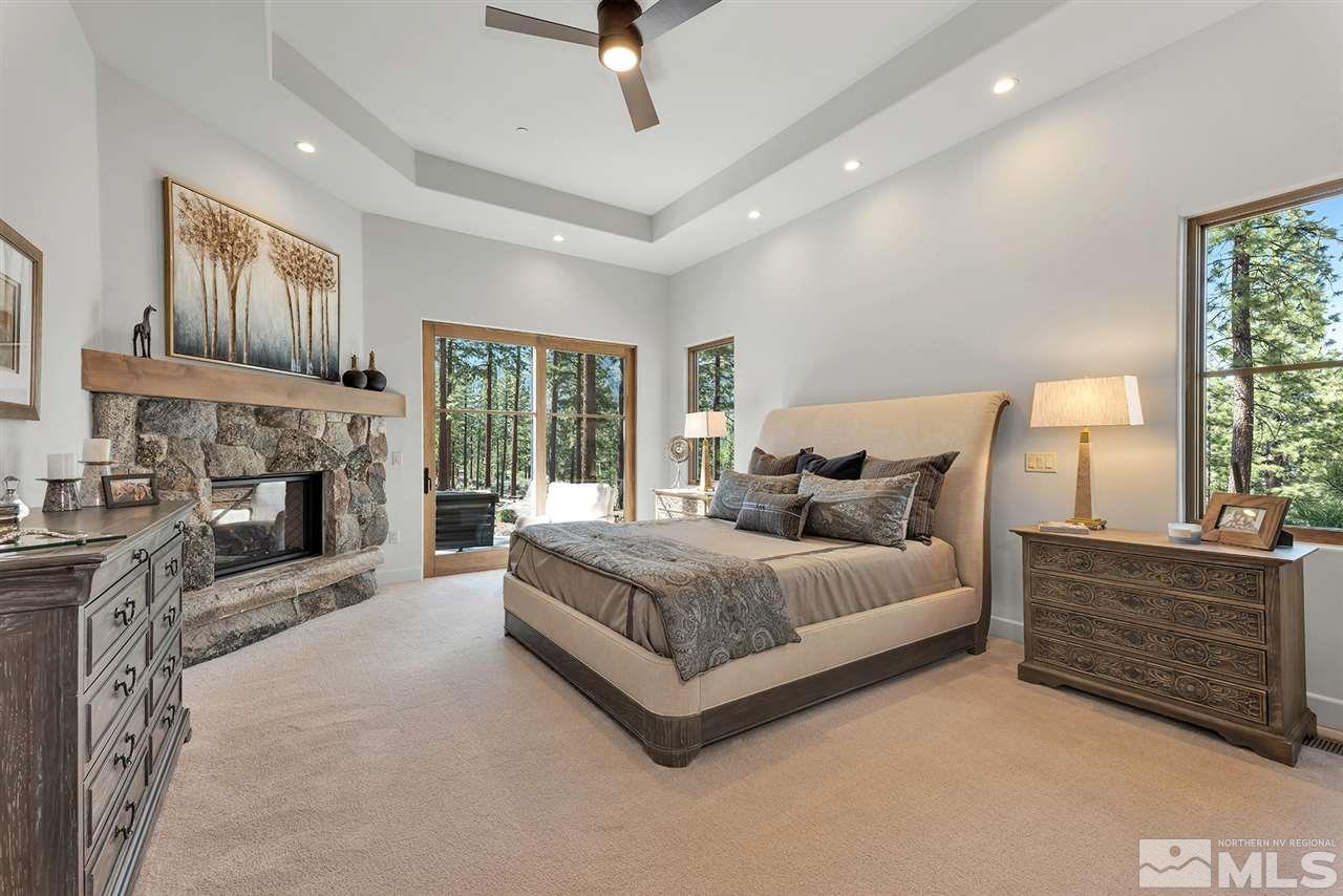 249 Mill Race Loop Carson City, NV 89705 - Photo 17 of 40 a spacious bedroom with a bed and a fireplace
