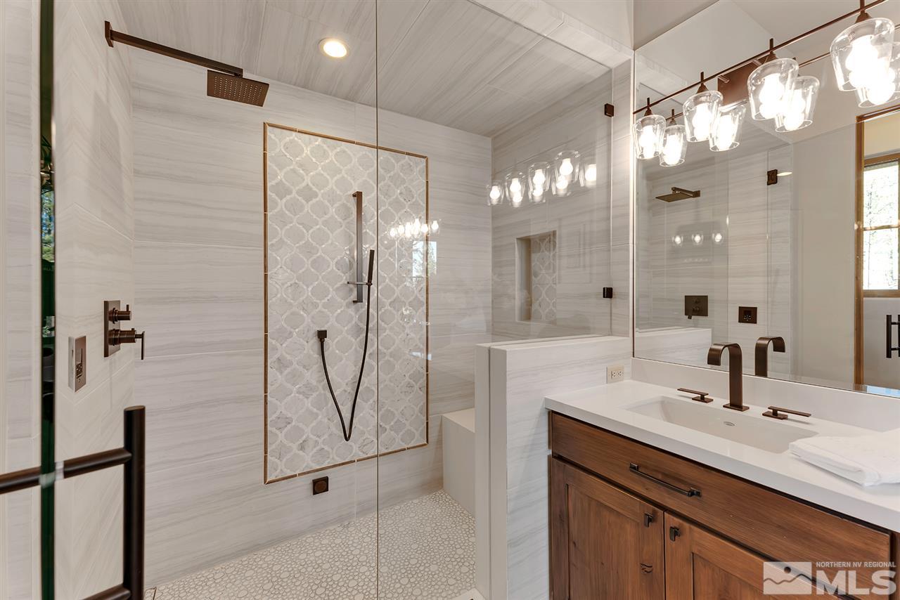 249 Mill Race Loop Carson City, NV 89705 - Photo 21 of 40 a bathroom with a double vanity sink mirror and shower