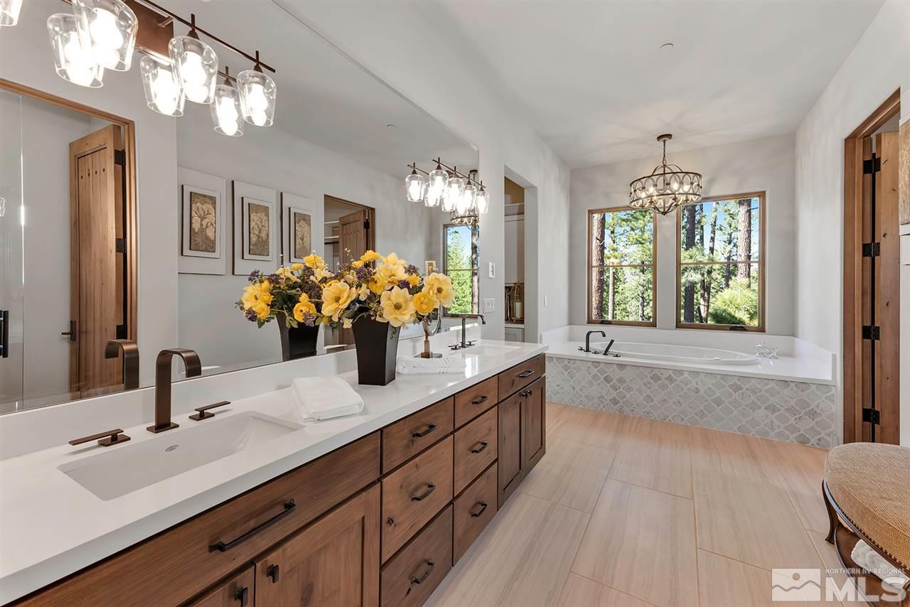 249 Mill Race Loop Carson City, NV 89705 - Photo 22 of 40 a bathroom with double vanity sinks a large mirror and a shower