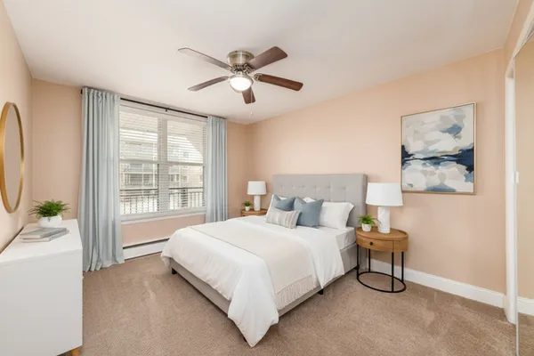 a bedroom with a large bed and a chandelier